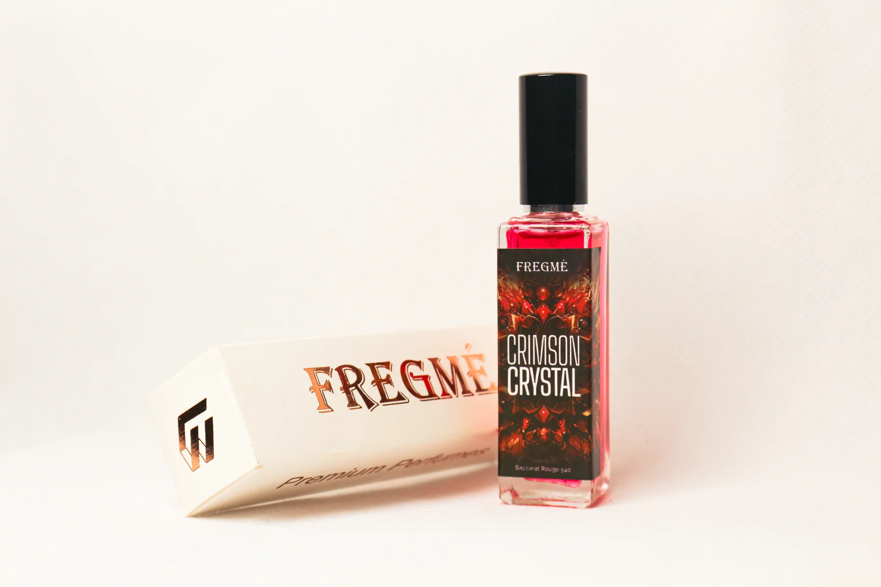 Studio product photograph of FREGME perfume packaging